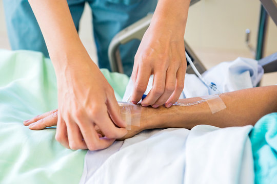 Nurse Starting An IV Line