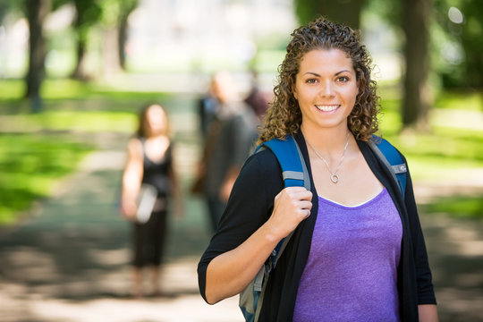 Happy Female Student Standing At Campus