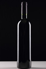 bottle with red wine and glass