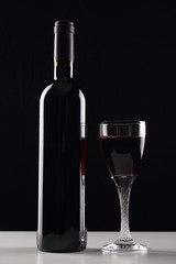 bottle with red wine and glass