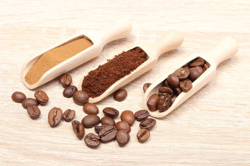 Grains, ground and instant coffee on wooden spoon