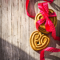 Heart shaped sugar cookie tied with red ribbon