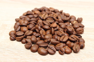 Heap of coffee on wooden background
