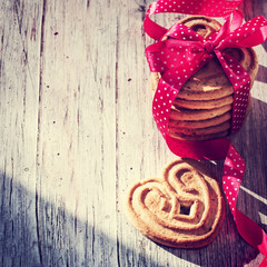Heart shaped sugar cookie tied with red ribbon