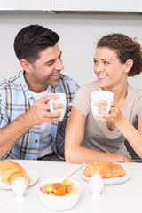 Obraz na płótnie Canvas Attractive couple sitting having breakfast together