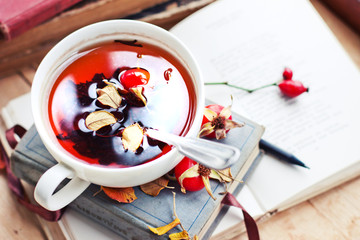 rosehip tea on old books