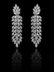 Diamond Earrings on a black reflective background