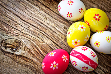 Obraz na płótnie Canvas Colorful Easter eggs on wooden background