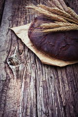Freshly baked traditional bread on wooden table