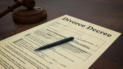 divorce decree paper with a pen, gavel and rings in the scene