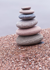 Fototapeta na wymiar tower of stones on sand