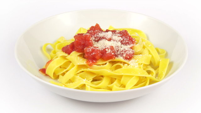 tagliatelle whit tomato sauce rotating on a white background