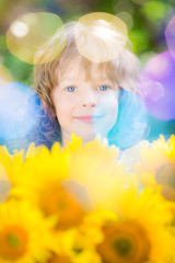 Child with bouquet of beautiful sunflowers