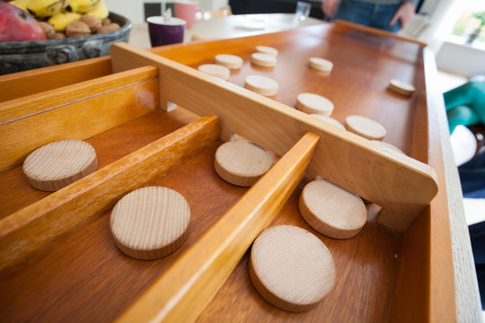A traditional Dutch game called 'sjoelen'. The wooden disks hove