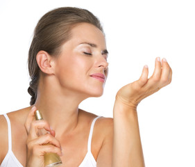 Young woman enjoying perfume