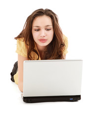 A young woman lying on the floor with a laptop