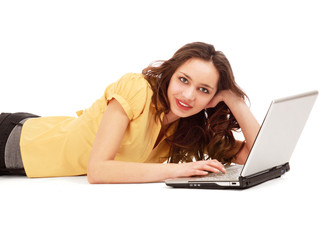 A young woman lying with a laptop.