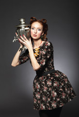 Girl in retro style posing samovar and bagels.