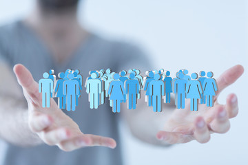 group -  Businessman holding 3D rendering group of blue people 