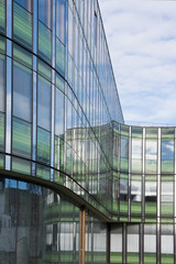 Office building with shiny blue glass on a sunny day