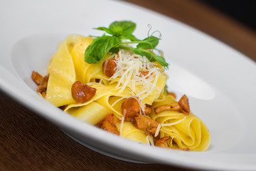Image of pasta with chanterelle served in white dish