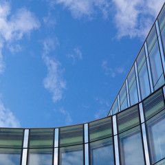 Office building with shiny blue glass on a sunny day