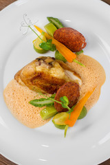 Image of tasty chicken with vegetables in dish in restaurant