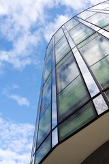Fototapeta na wymiar Angled shot of an office building with shiny blue glass