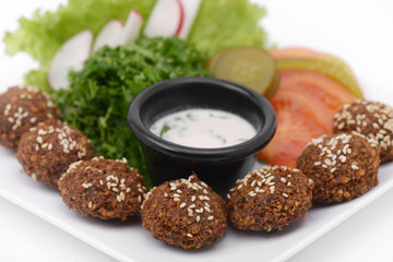 Falafel dish with veggies and tartar sauce