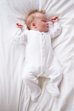 Newborn Baby Girl Sleeping In Bed