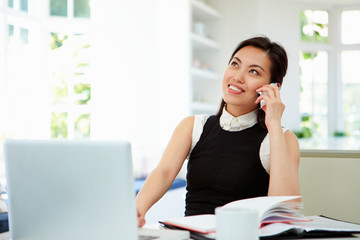 Asian Businesswoman Working From Home Using Mobile Phone