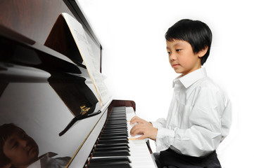 Young Asian boy playing piano