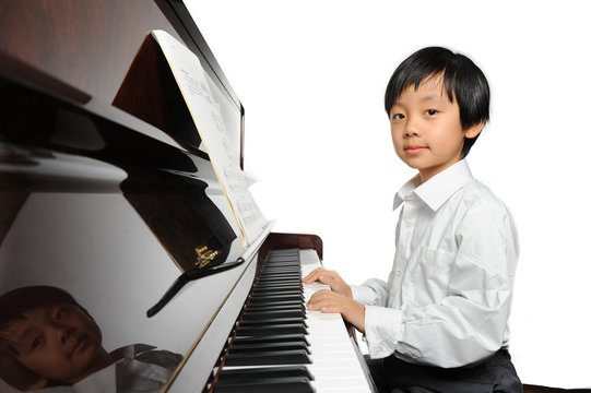 Young Asian boy playing piano