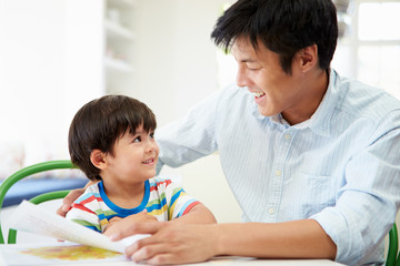 Father Helping Son With Homework