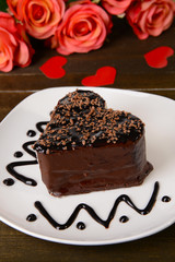 Sweet cake with chocolate on plate on table close-up