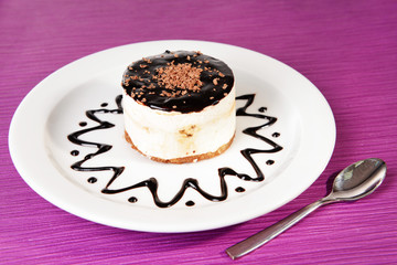 Sweet cake with chocolate on plate on table close-up
