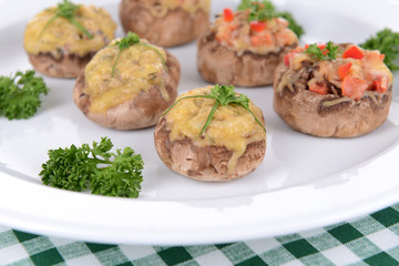 Stuffed mushrooms on plate on table close-up