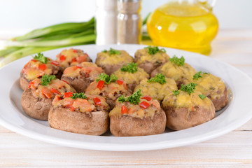Stuffed mushrooms on plate on table on light background