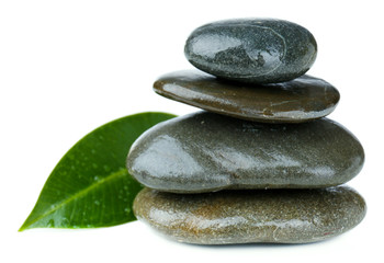 Spa stones with green leaf, isolated on white