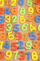 Colorful numbers on wooden background
