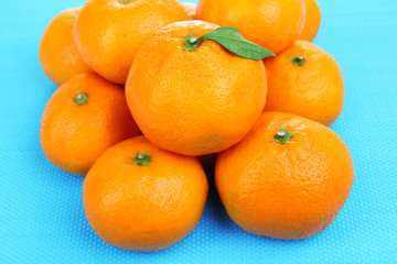 Ripe sweet tangerines, on color background