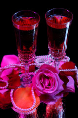 Composition with pink  wine in glasses, bottle  and  roses