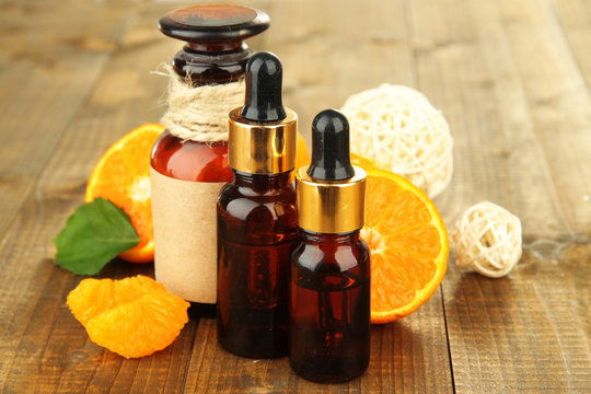 Tangerine essential oil and tangerines on wooden table