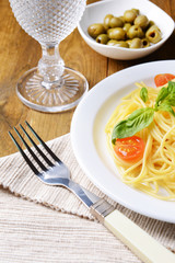 Delicious spaghetti with tomatoes on plate on table close-up