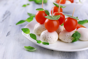 Tasty mozzarella cheese with basil and tomatoes