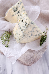 Tasty blue cheese with thyme on paper