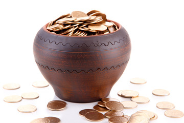 Golden coins in ceramic pot, isolated on white background
