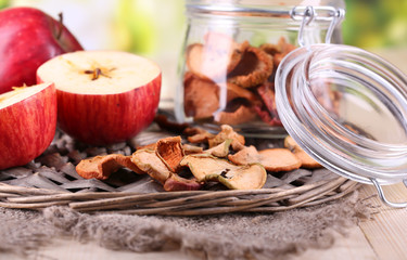 Dried apples in glass jar, on   bright background