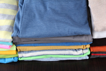 Stack of colorful clothes, on dark background