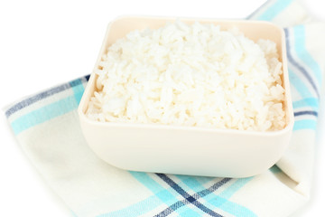 Cooked rice in bowl on napkin close up